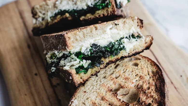Brown Butter Spinach and Ricotta Grilled Cheese on wooden cutting board