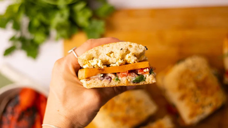 Hand holding Cumin-Roasted Squash and Feta Panini