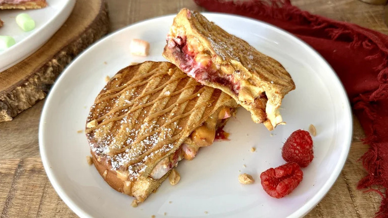 Fruity Fluffernutter Dessert Panini on white plate with raspberries