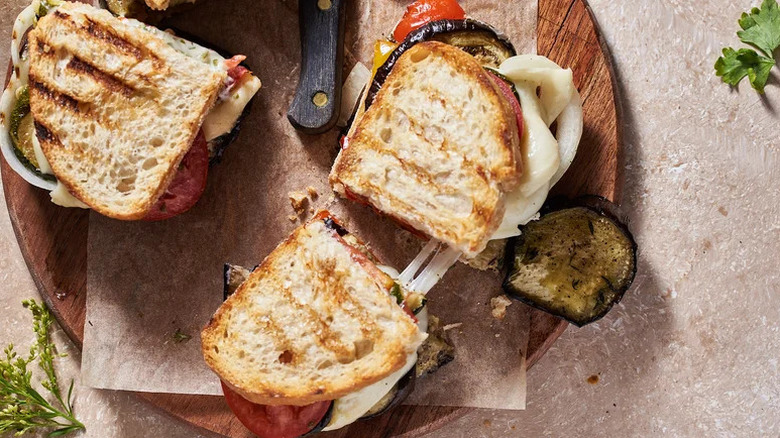 Ratatouille-ish Eggplant Panini with Herb Aioli on wooden cutting board