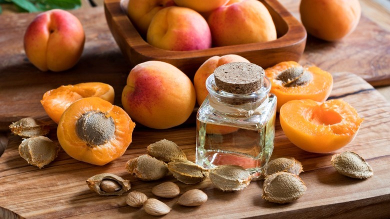 apricots and pits on wooden board