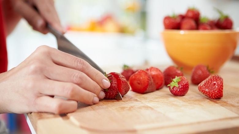 cutting off strawberry tops