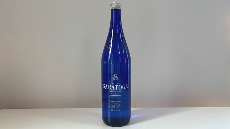 blue bottle of saratoga spring water on table