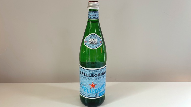 green bottle of sparkling san pellegrino on table