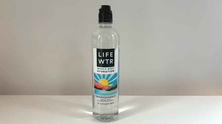 bottle of life wtr on table