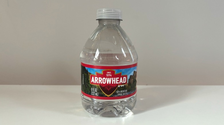 small bottle of arrowhead water on table