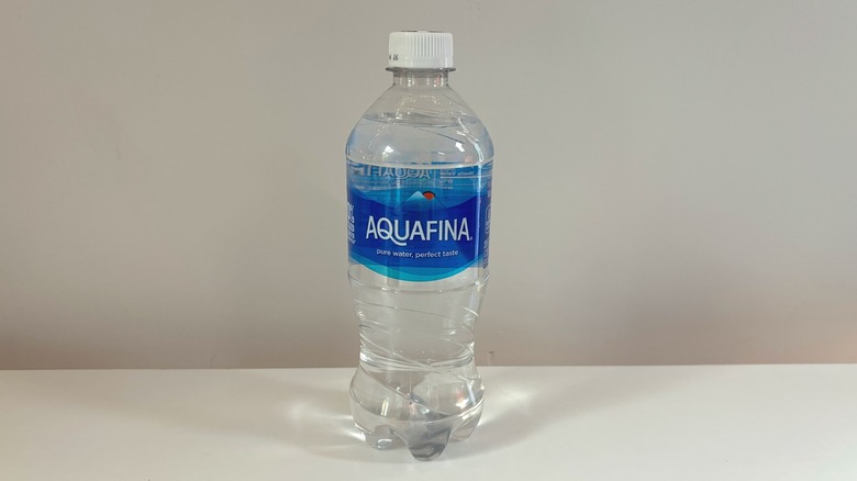 bottle of aquafina water on table