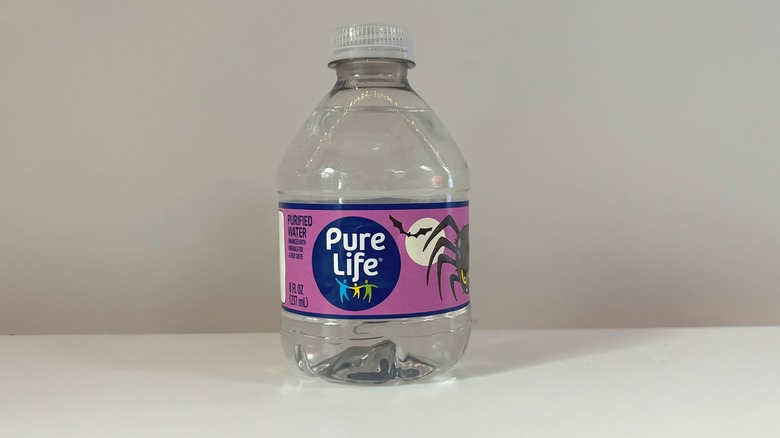 bottle of pure life water on table