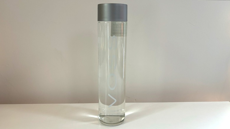 glass voss water bottle on table