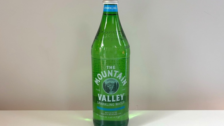green bottle of mountain valley sparkling water on table