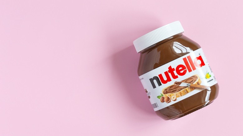 Jar of Nutella on pink background