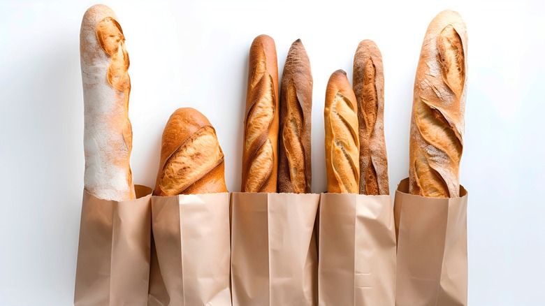 Baguettes in bags on white