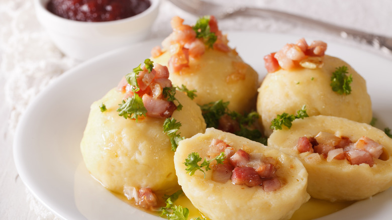 Kroppkakor on plate with lingonberry sauce