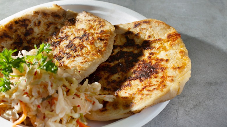 Pupusas on plate with curtido