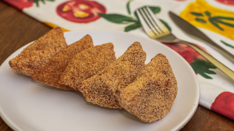 Rissóis on plate with napkin and cutlery