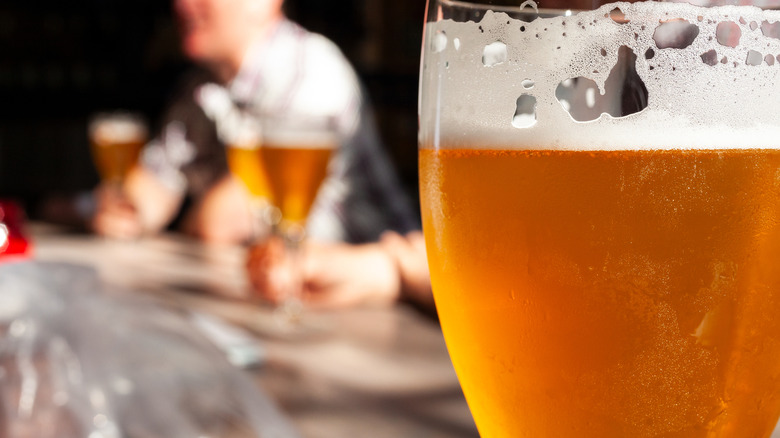 Close-up of beer with bar in background