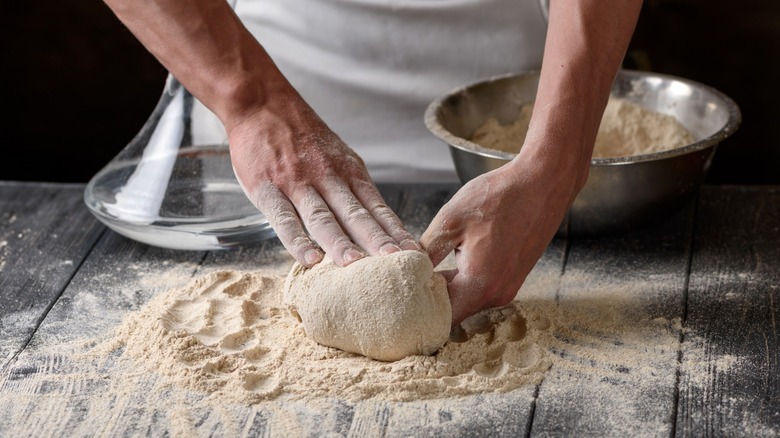 Hands kneading bread dough