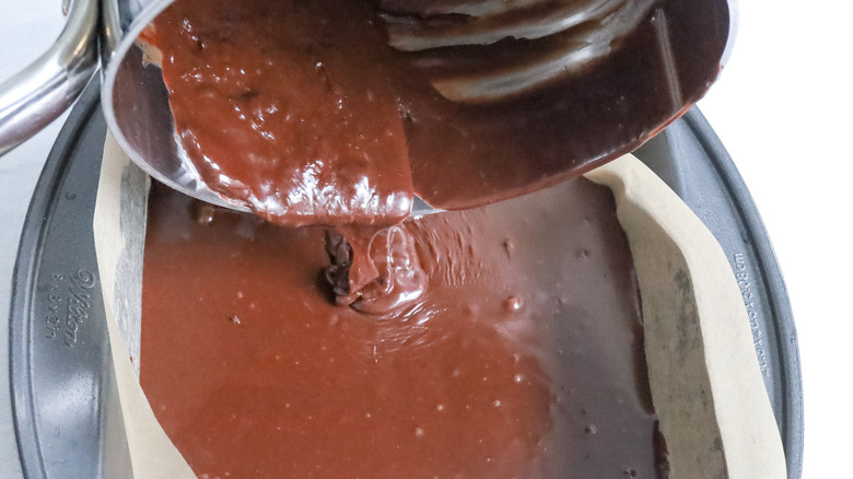 melted chocolate pouring into pan