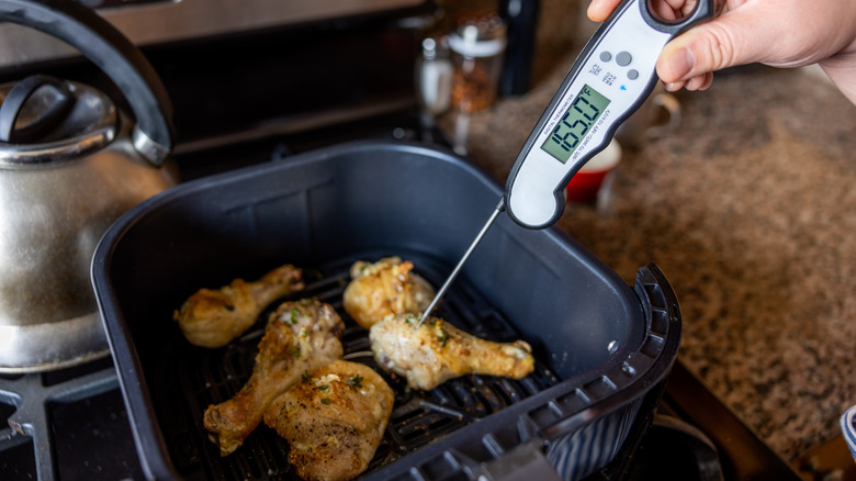Meat thermometer checking chicken in air fryer