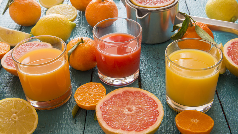 Three glasses of fruit juices with fruits