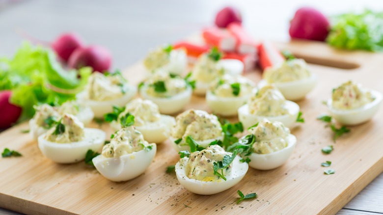 deviled eggs on a cutting board