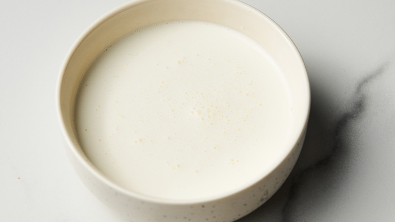 Heavy cream sits in a marble bowl.