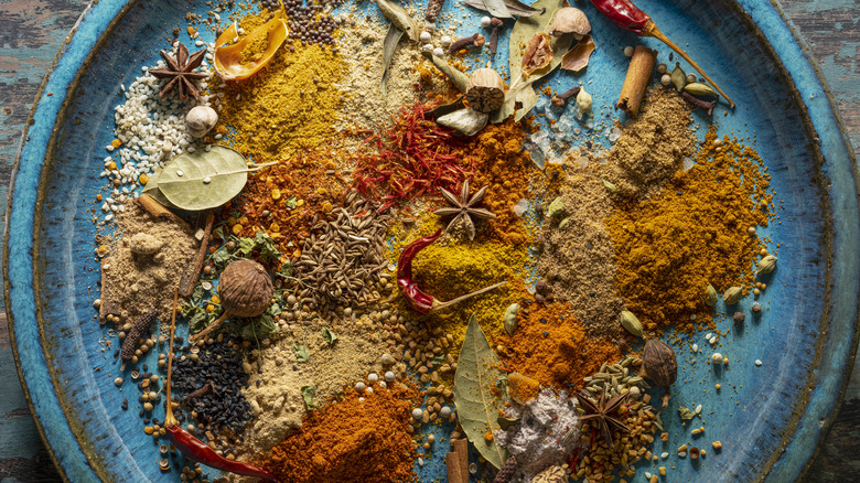 blue plate full of Indian spices