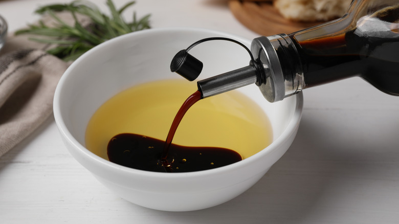 Balsamic vinegar being poured into olive oil