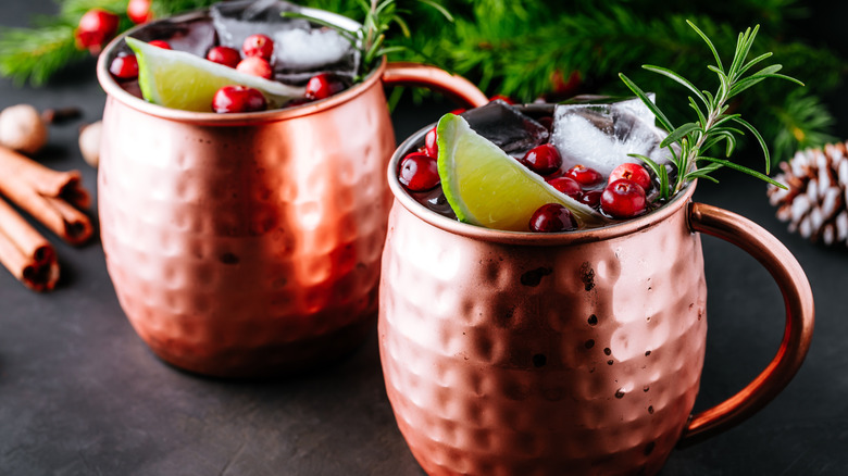 2 festive moscow mules with redcurrants, lime, and rosemary