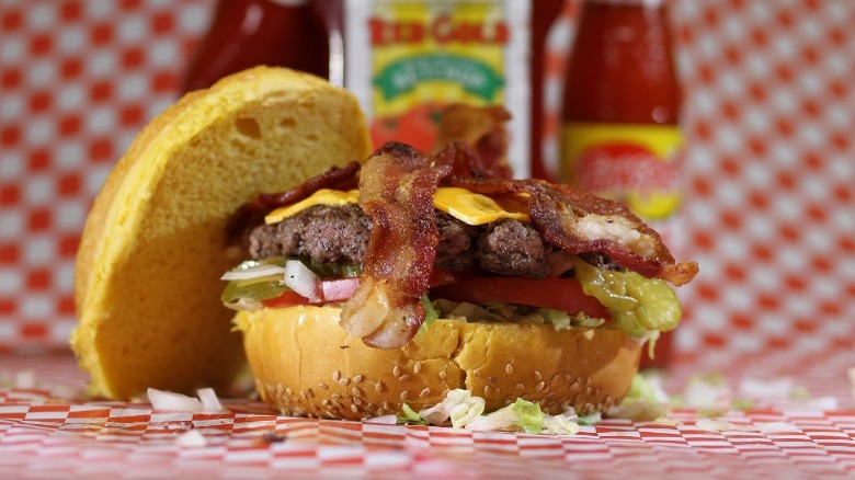 Bacon cheeseburger on checkered parchment