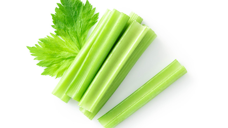 Celery sticks on white background