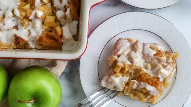 Apple fritter breakfast casserole in dish with plate