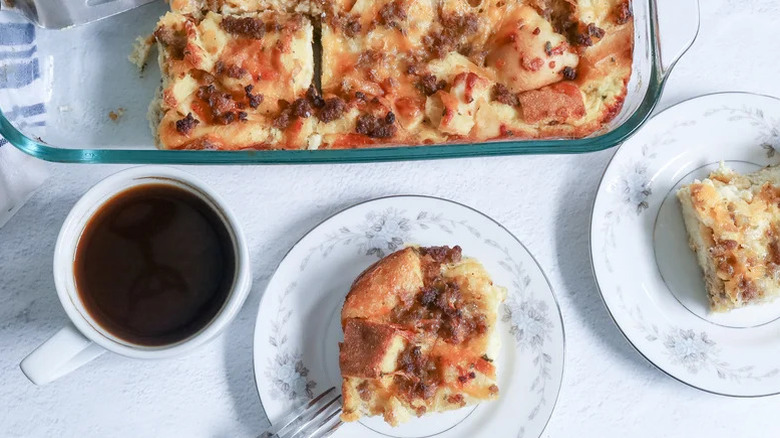 Brunch strata in a casserole dish with plate