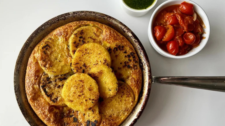 Polenta frittata in pan with cherry tomatoes
