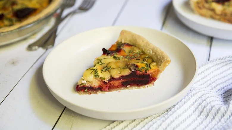 Slice of beetroot quiche on a plate