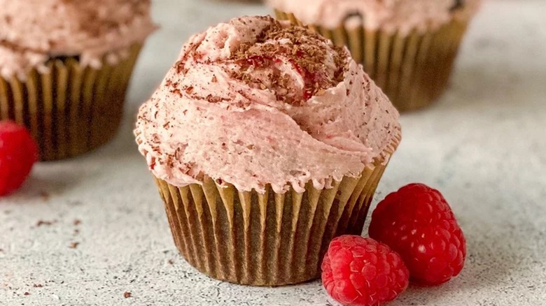 Frosted cupcake with raspberries