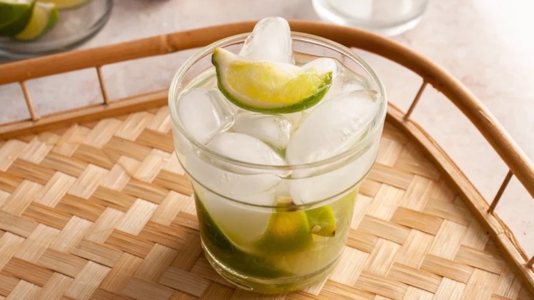 Caipirinha with lime wedges