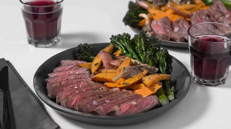 Sliced steak with potatoes and broccolini 