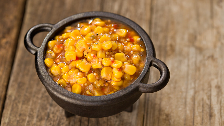 Salsa with corn on table