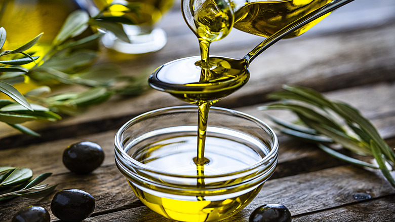 Olive oil pouring in bowl