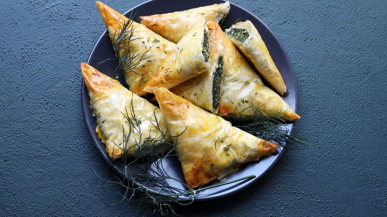 Spanikopita with dill sprigs