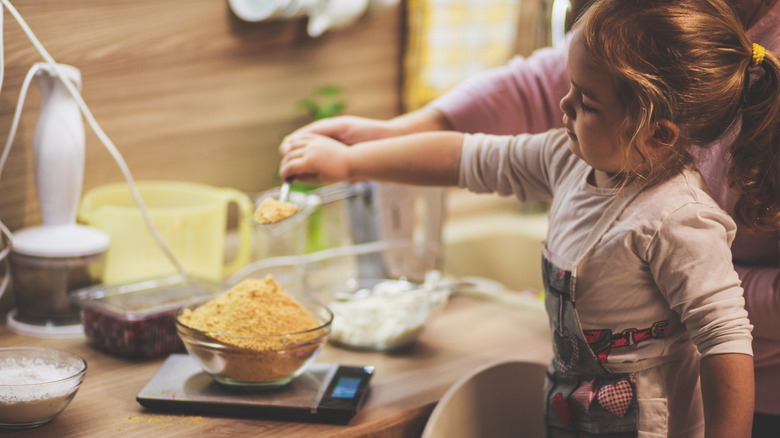 Toddler pouring into bowl 