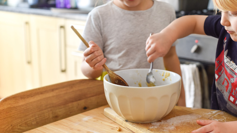 Folks mixing cookie batter in bowl