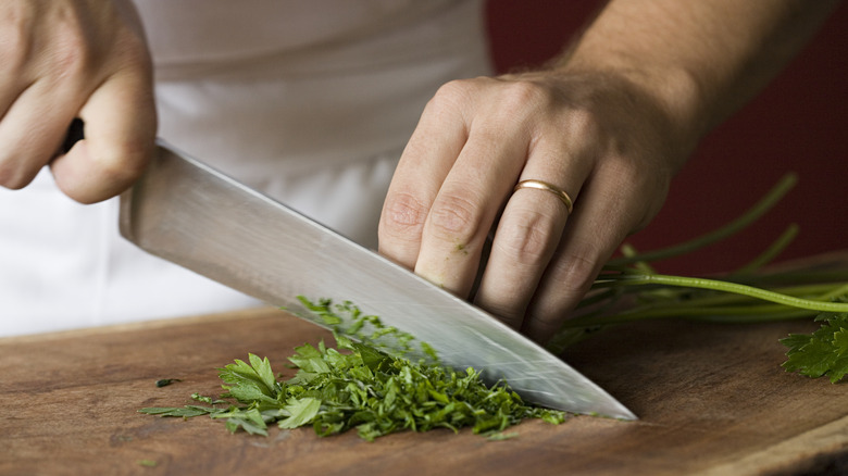 Chef's knife chopping herbs