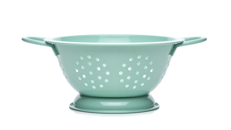 Blue colander on white background