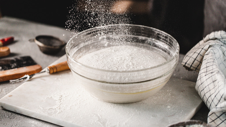 Glass mixing bowl with flour