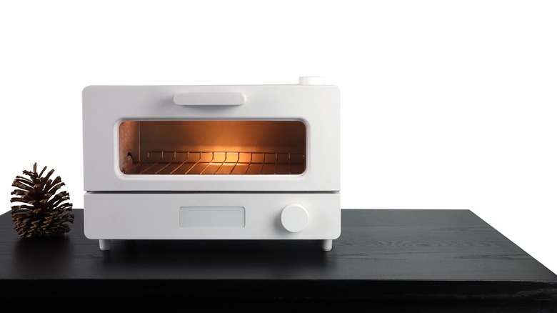 White toaster oven on black counter