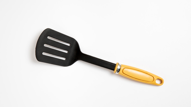 Black turner spatula white background