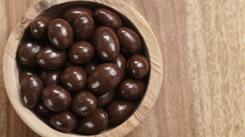 Dark chocolate covered almonds in bowl