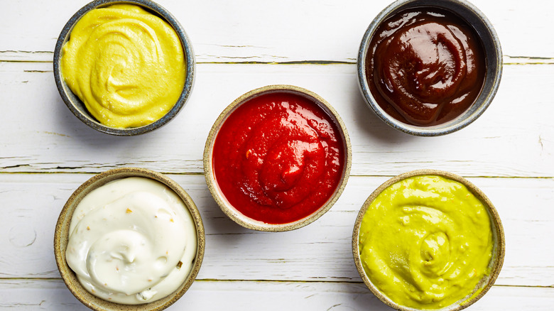 Condiments in cups on table